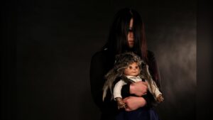 The Sacred Riana holding her doll