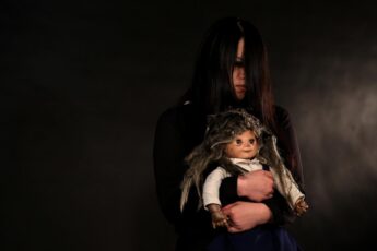 The Sacred Riana holding her doll